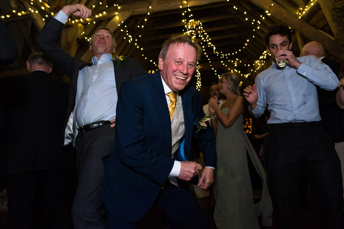 Mike is photographed dancing at his daughters chilham church wedding reception