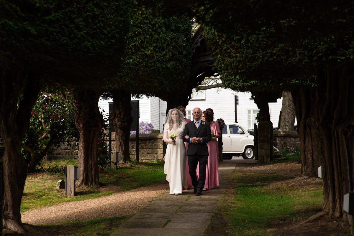 Flora and father walk down church path for wedding ceremony in Brenchley