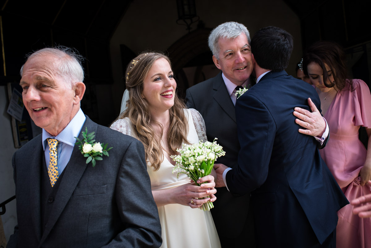 Family congratulate Flora and James after their wedding in Brenchley Kent