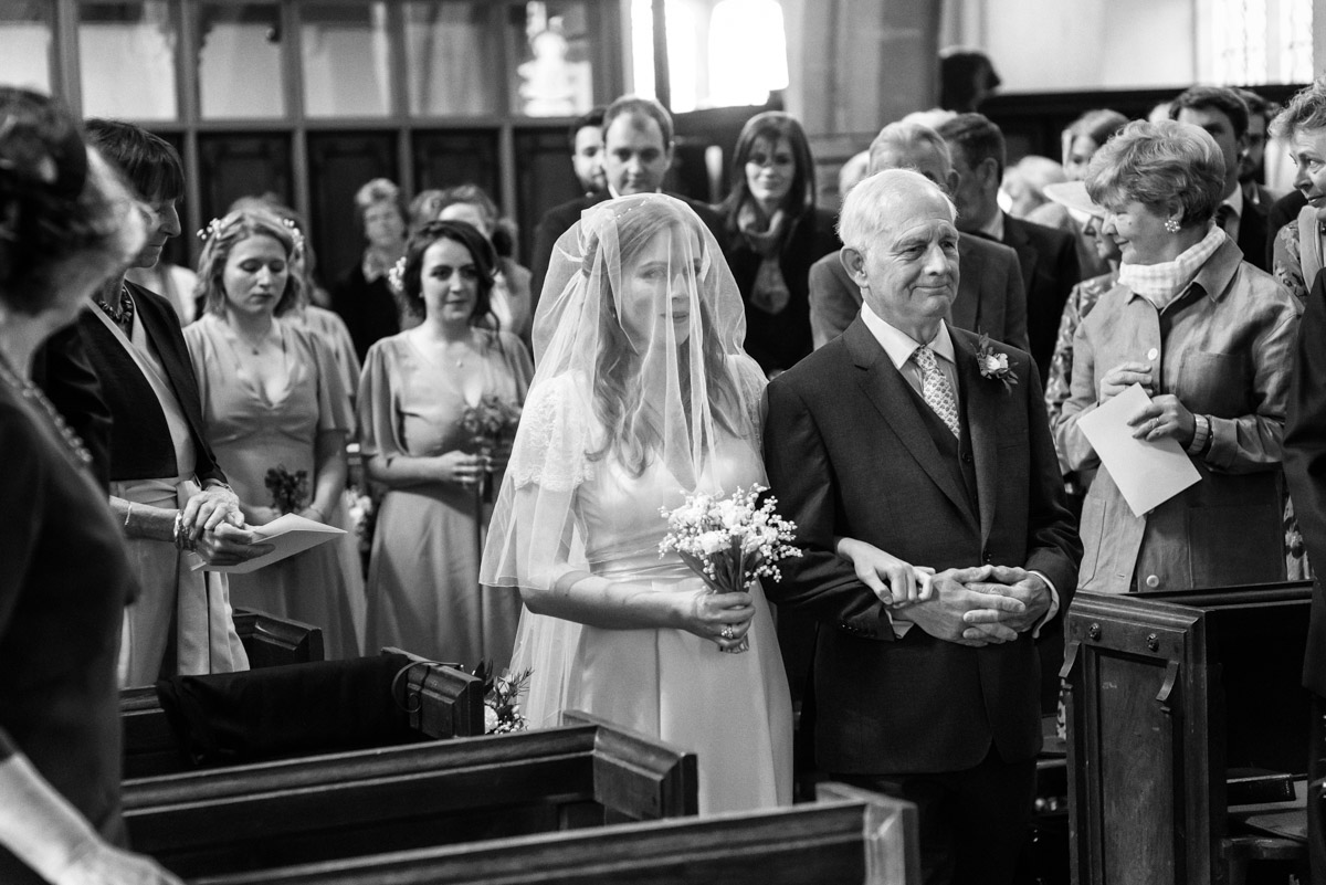 Flora is walked up aisle by father in Brenchley Church in Kent on her wedding day