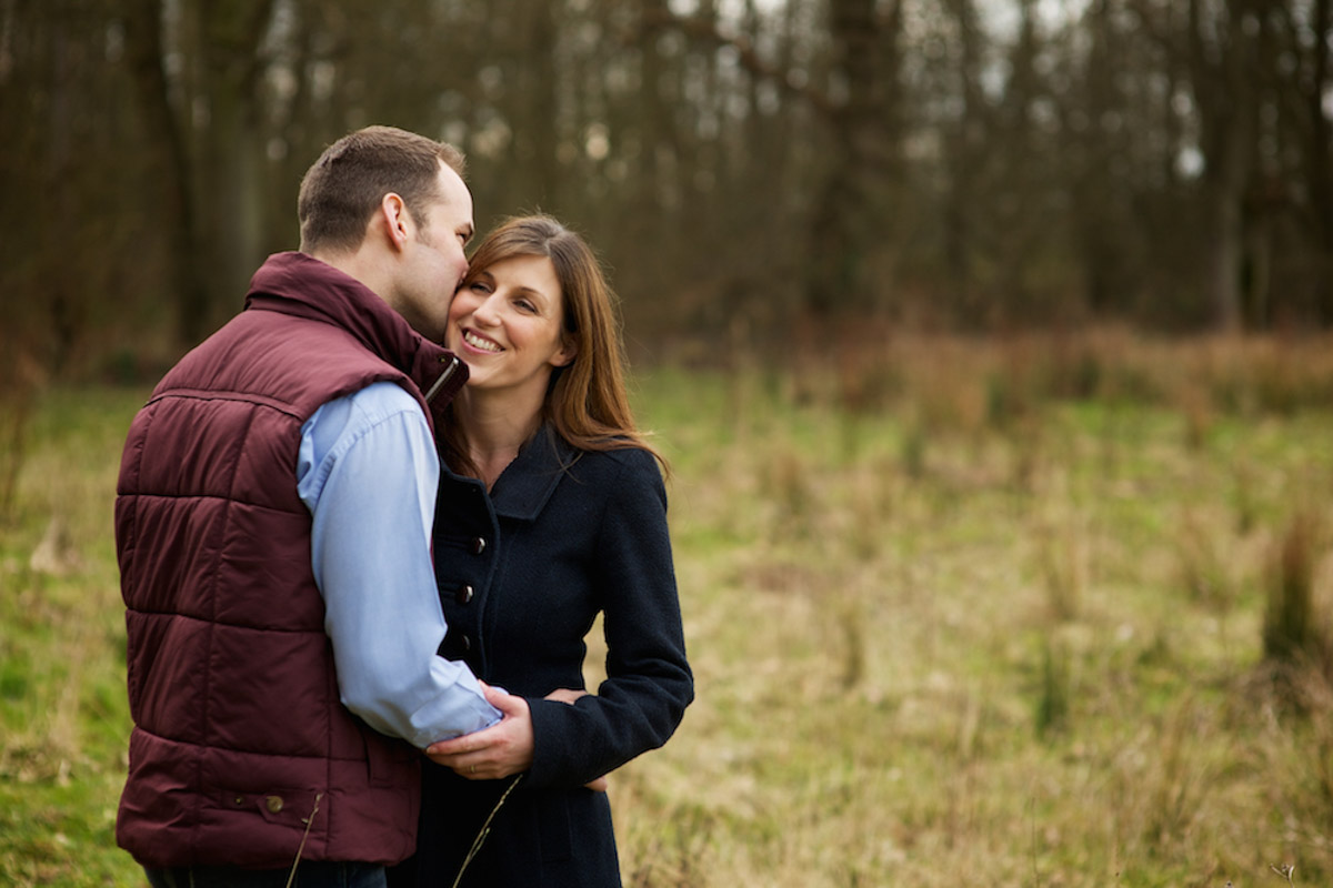 Photograph of Julia and Ryan by the woods during their pre wedding photography shoot