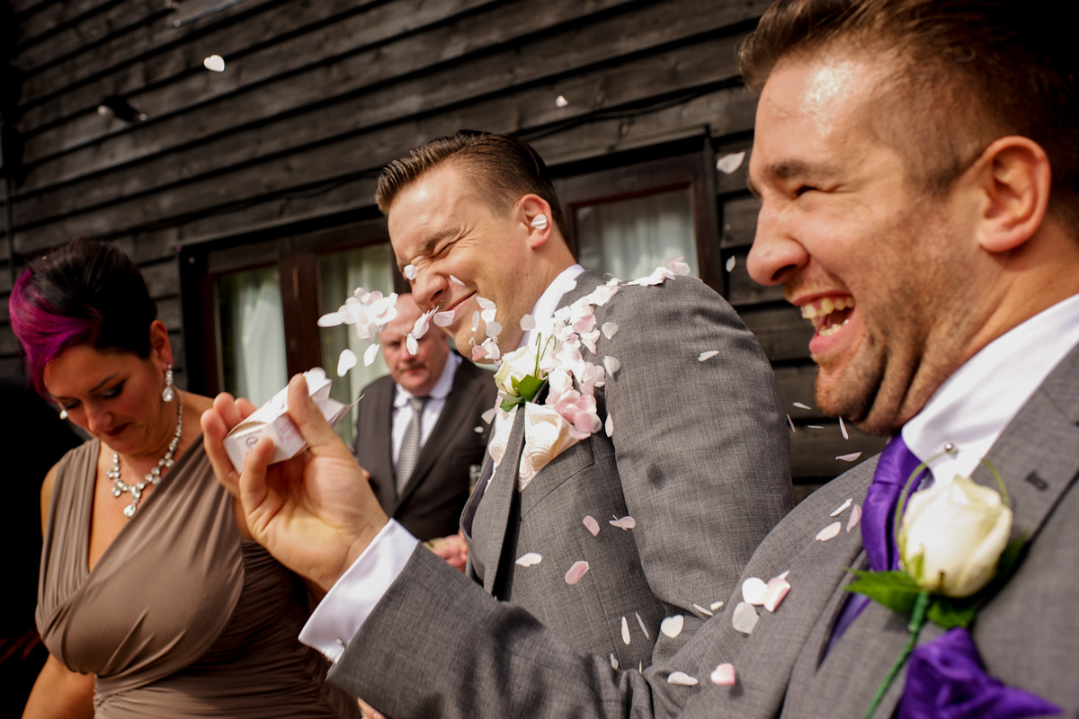 Photograph of Nick having confetti thrown in his face at his Old Kent barn wedding