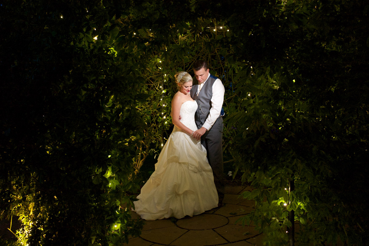 Emma and Nick photographed under fairy lights at the Old Kent barn wedding