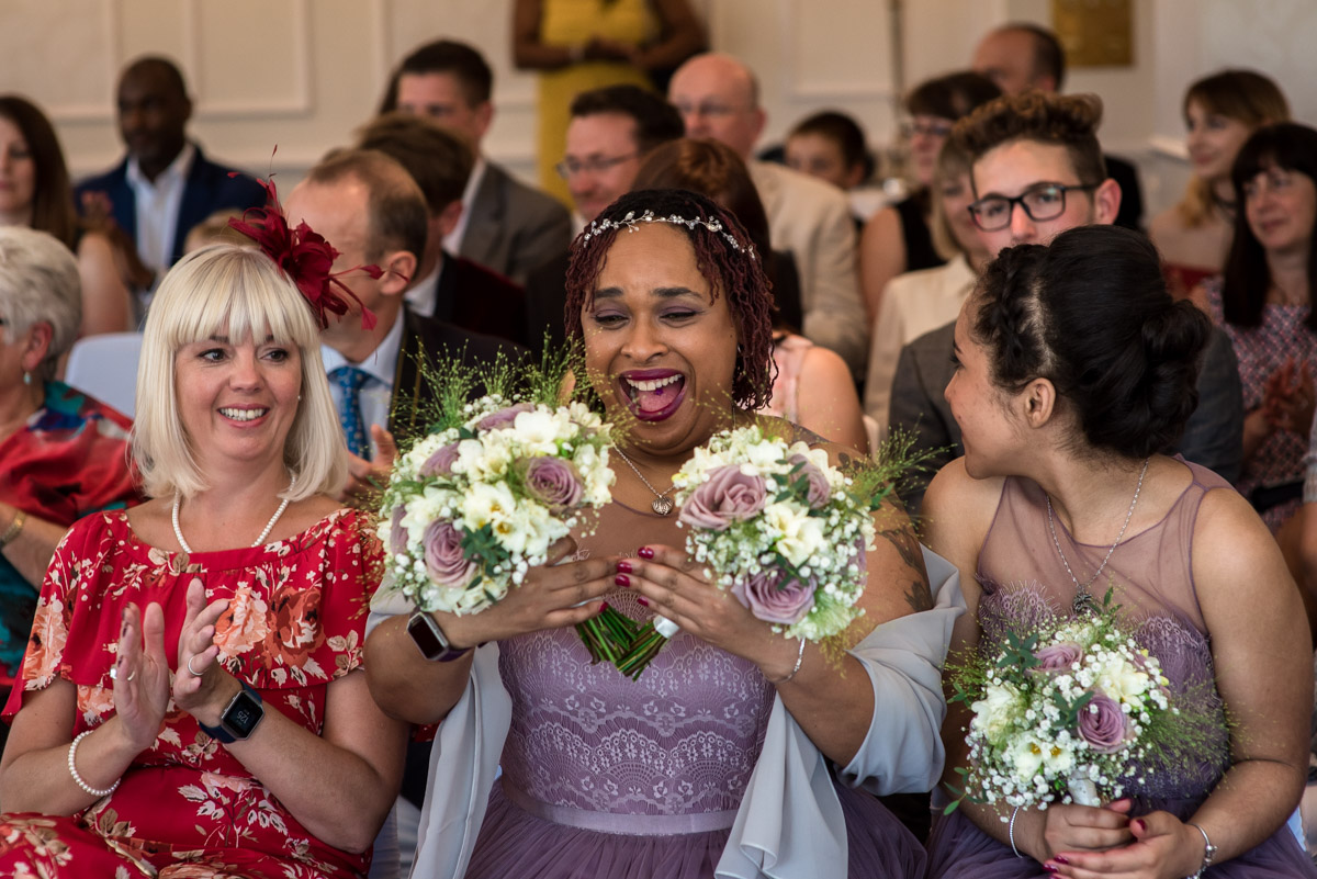 Bridesmaid photographed holding wedding bouquets during Hythe Imperial wedding