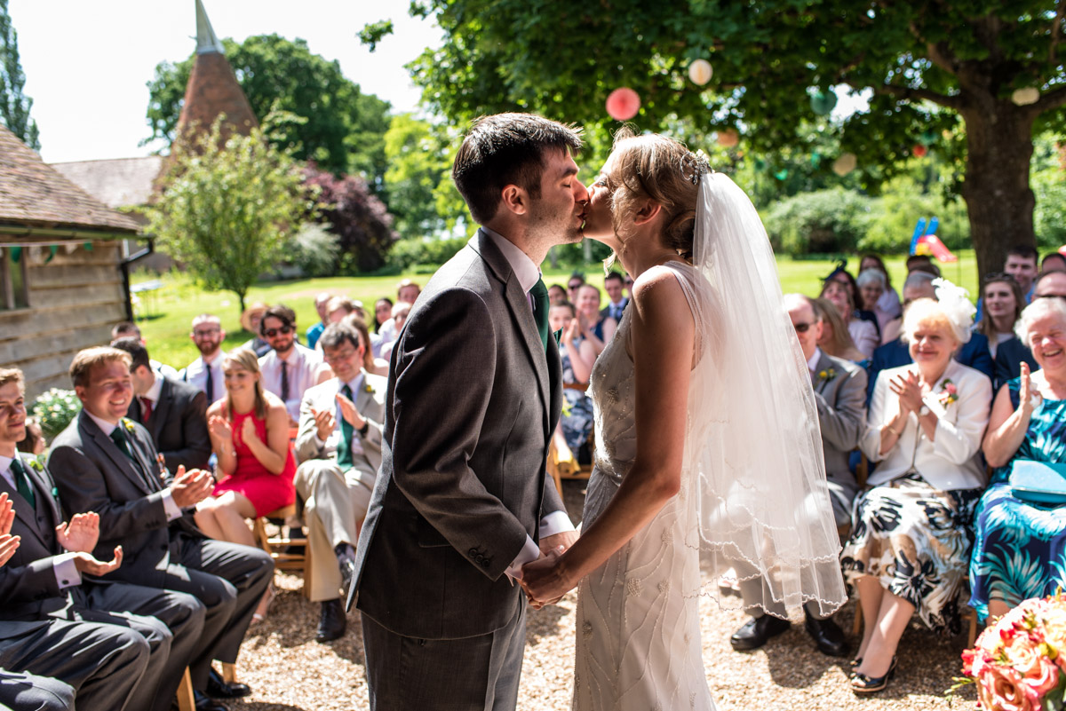 Beth and Toms first kiss, Ratsbury Barn wedding photography in Kent