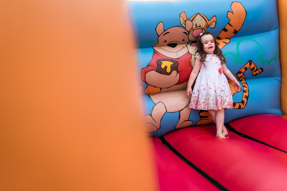 Photograph of flower girl on bouncy castle at rats bury Barn in Kent