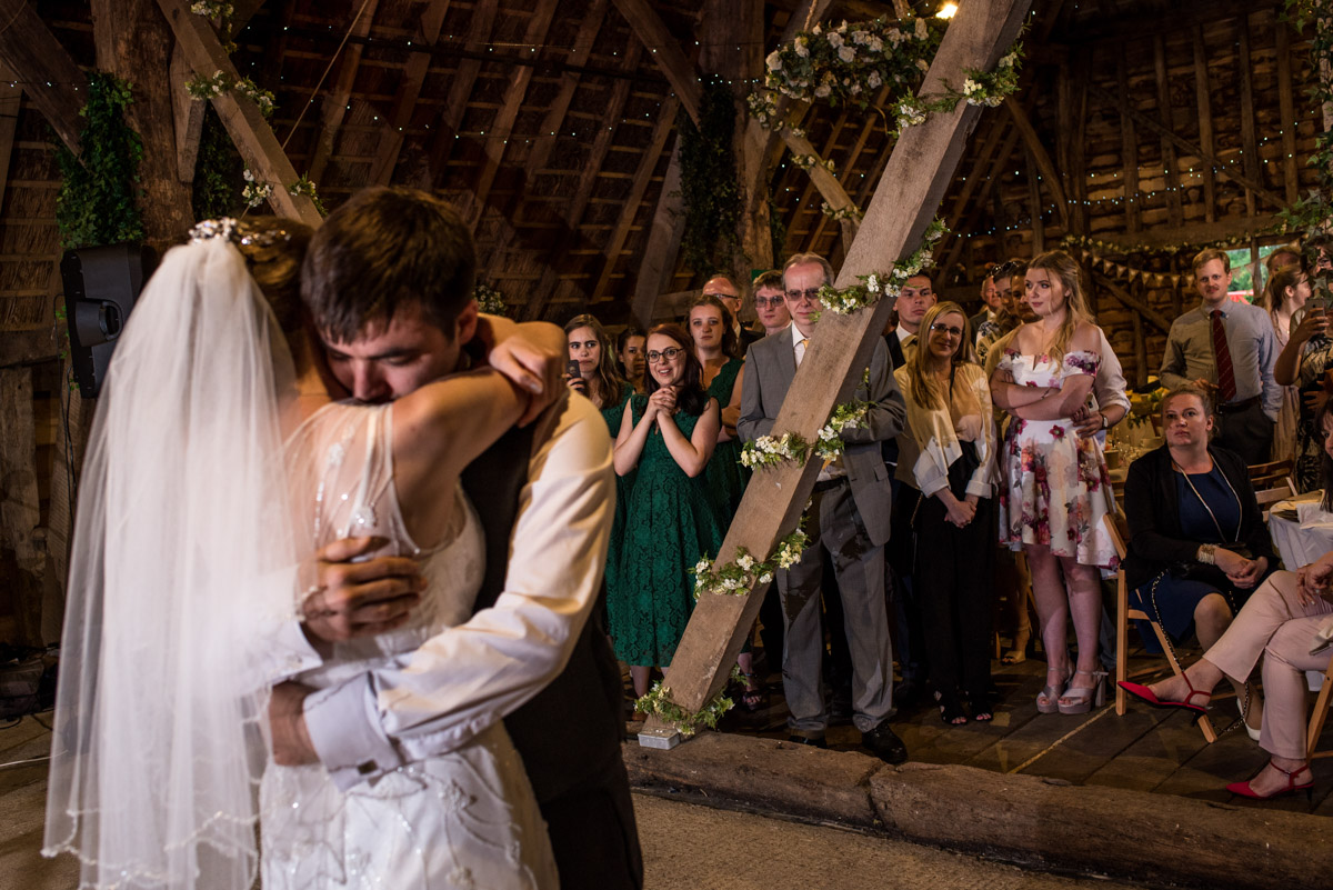 Beth and Tom embrace during their first dance on their wedding day at rats bury Barn