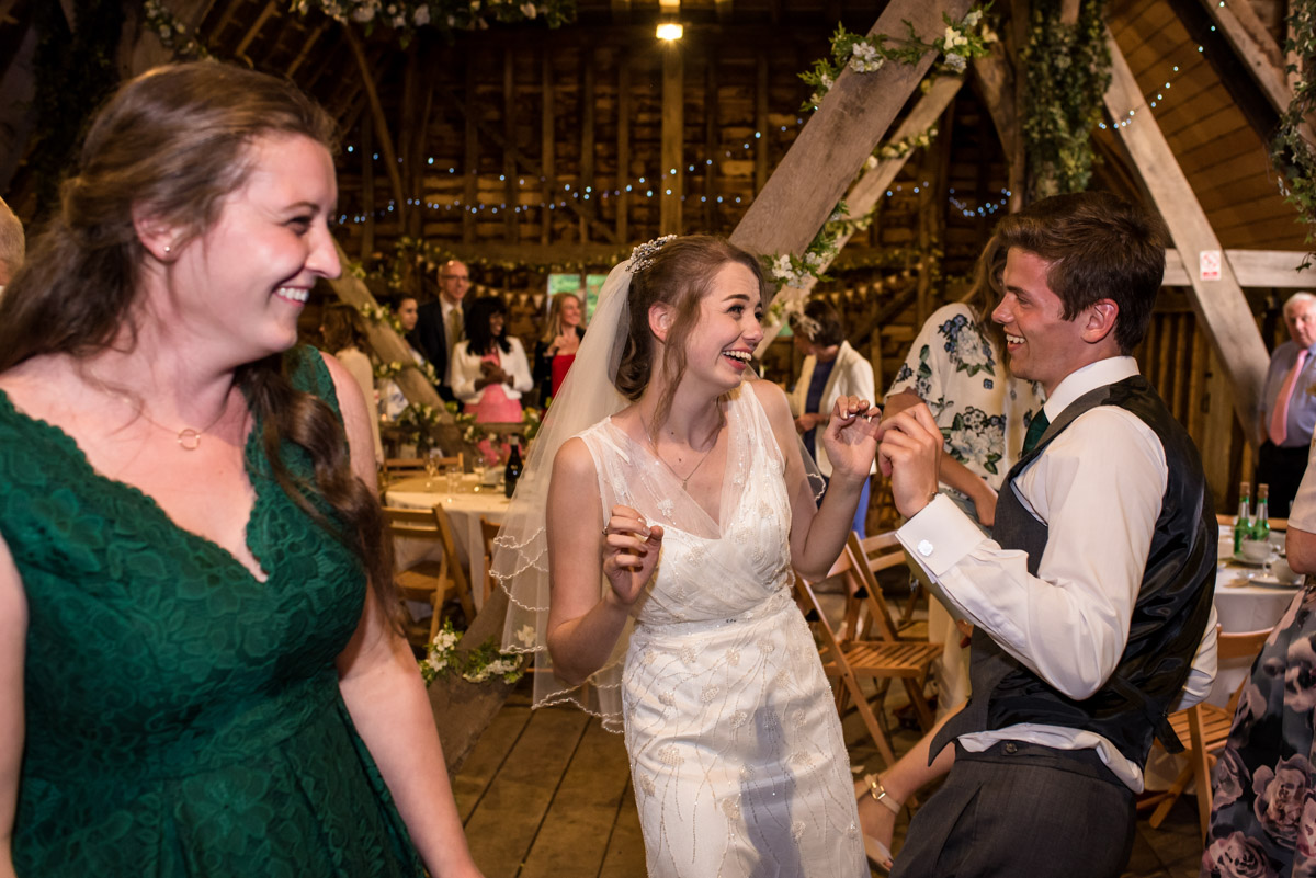 beth and her brother dancing at her wedding at Ratsbury barn