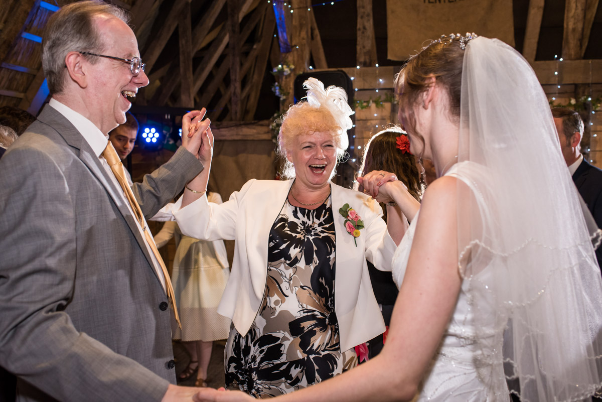 Beth dances with her parents on her wedding day at Ratsbury barn wedding in Kent