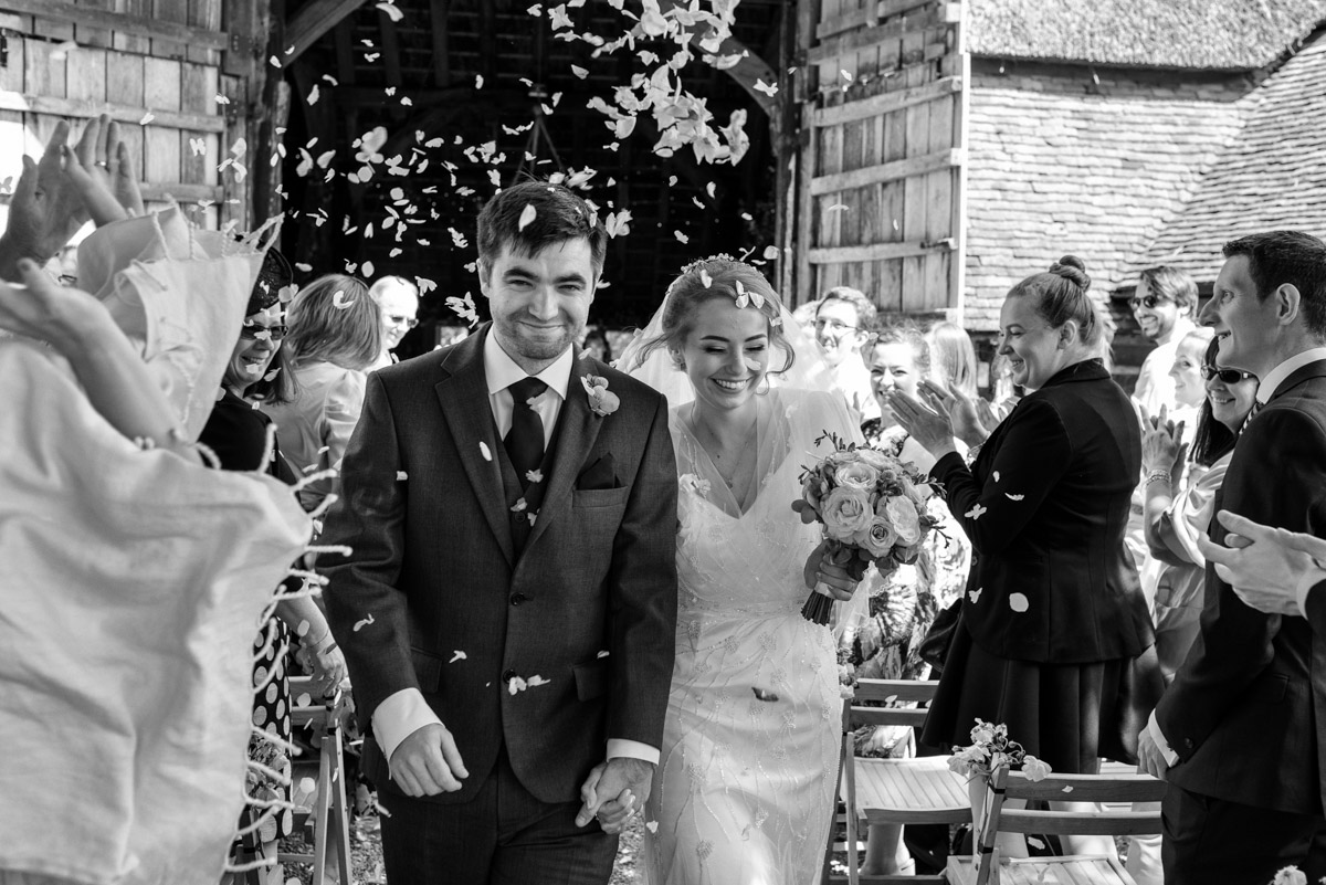 Rats bury Barn Wedding photography of Tom and Beths confetti throw