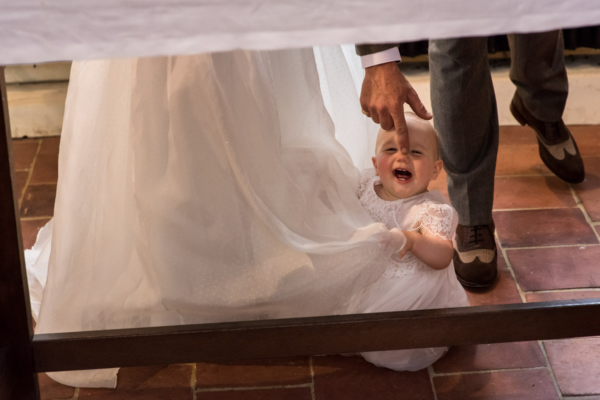 baby is photographed during Kent wedding during signing of the register