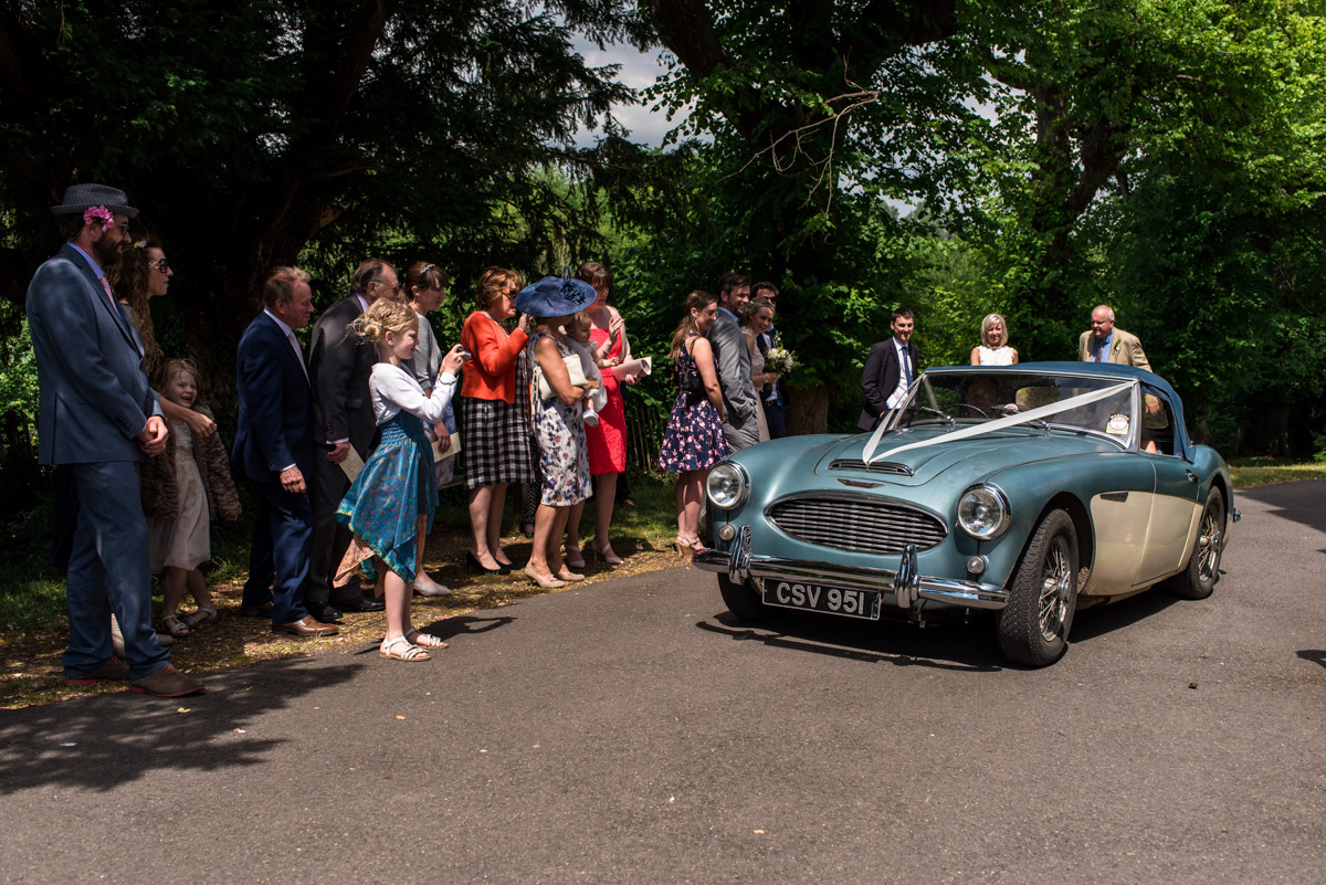 photograph of wedding car leaving St Marys church in Chilham Kent
