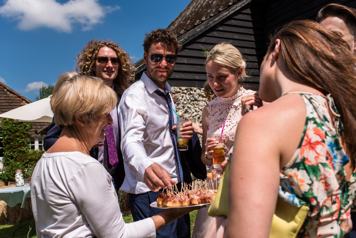Photograph of Anne and Joshs wedding guests enjoying canapés