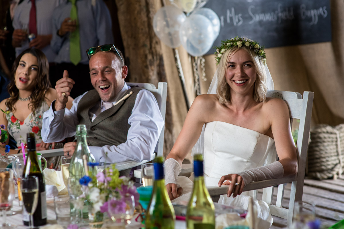 Josh and Anne are photographed during reception speeches at their Kent wedding