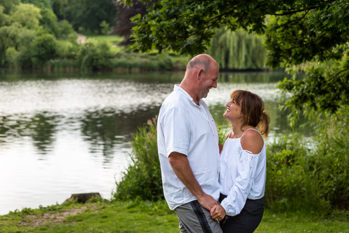 Pre wedding photography at Moat park in Kent, Debbie & Martin stand holding hands