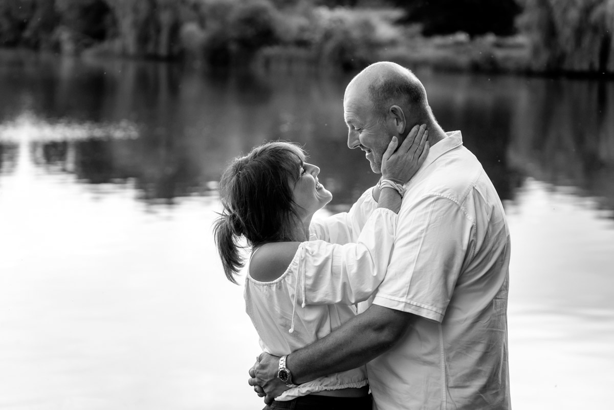 debbie holds Martins face in her hands during their pre wedding photography at Moat park in Kent