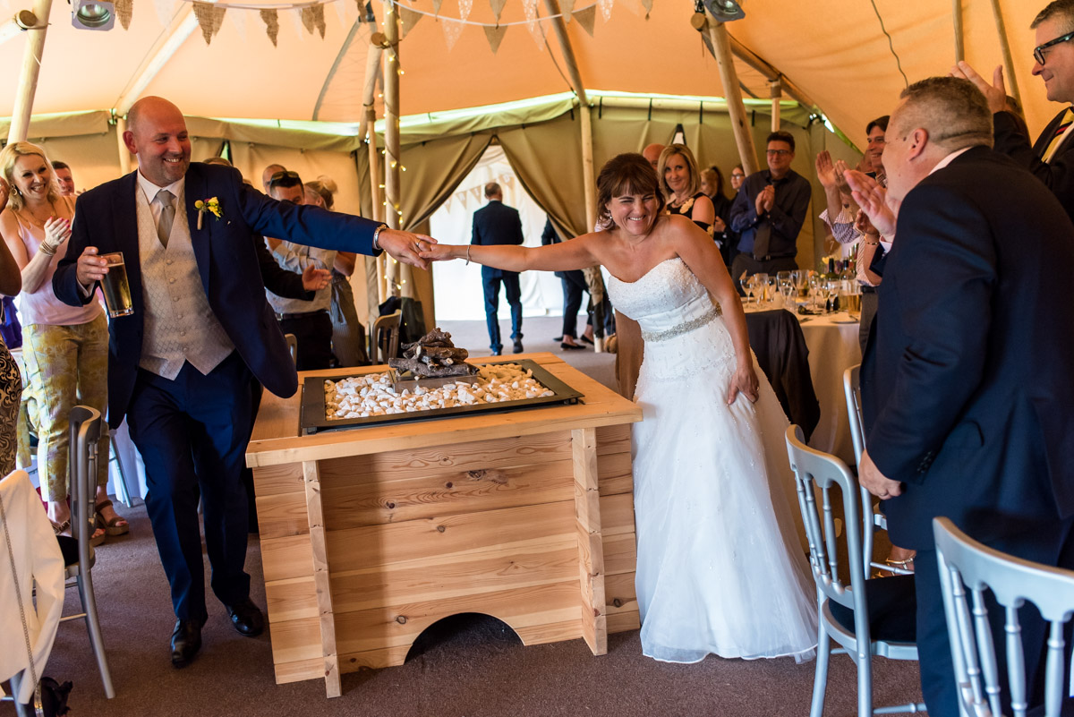 Photograph of Martin and Debbie entering the tipis for their wedding reception