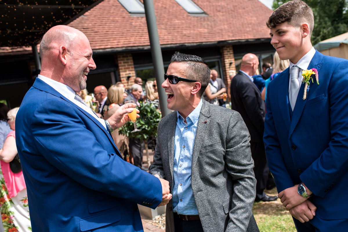 Photograph of wedding guest congratulating Martin after his wedding at The Gardens Yalding in Kent
