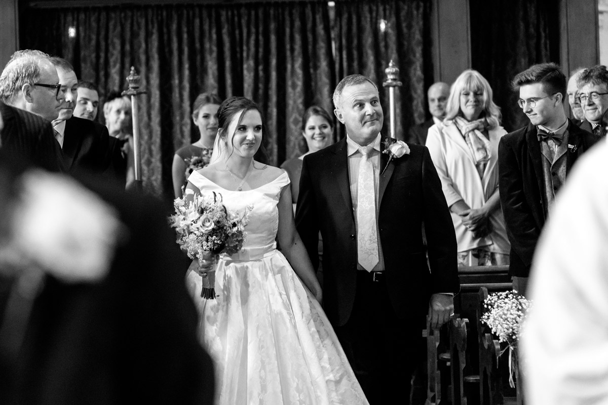 Emily and her dad photographed walking down aisle on her wedding day
