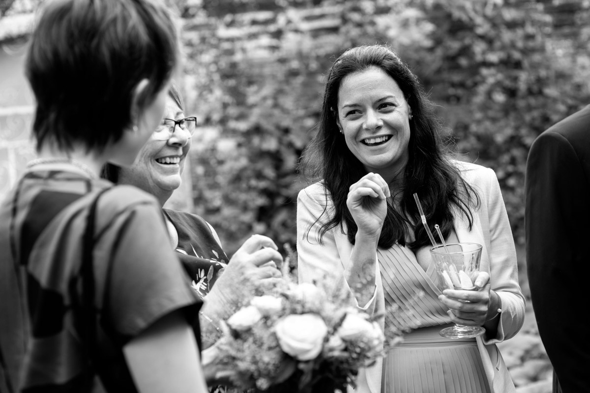 Wedding guests photographed having drinks at the secret garden in Kent