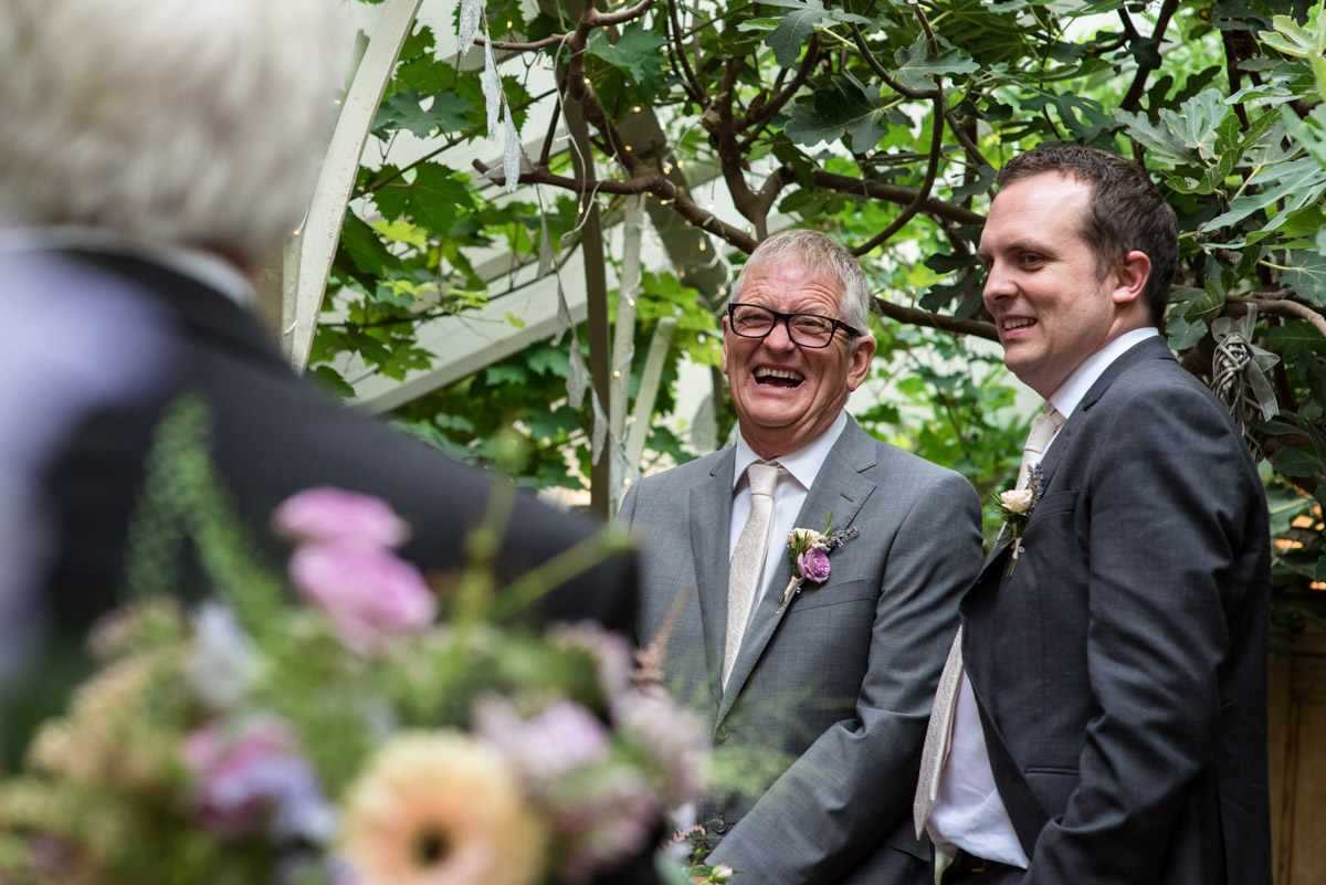Photograph of John and his best man in The Glass House at The Secret garden wedding venue