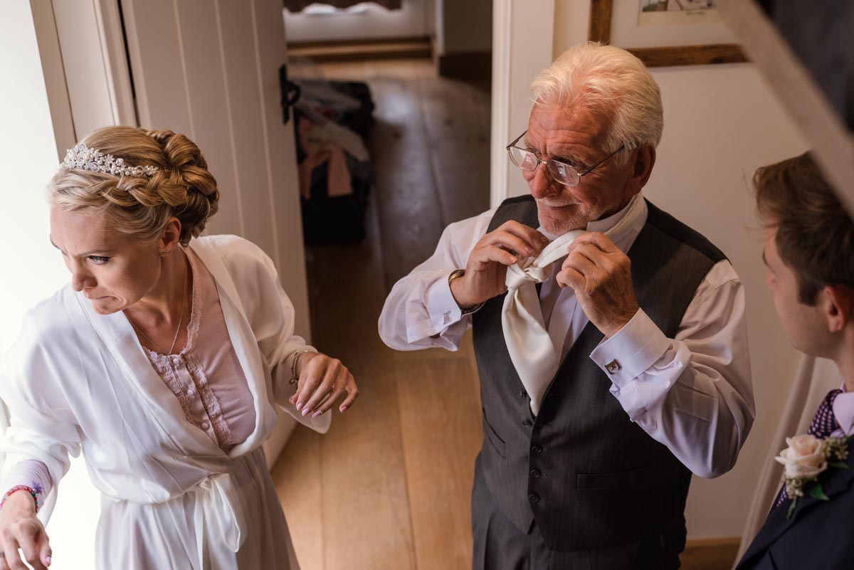 Photograph of Rebecca 7 her dad getting ready before her Smarten church wedding in Kent