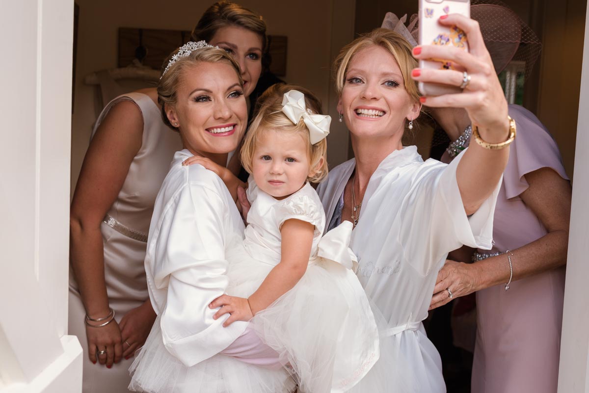 Group selfie of Rebecca and her bridesmaids before her smarden church wedding in Kent
