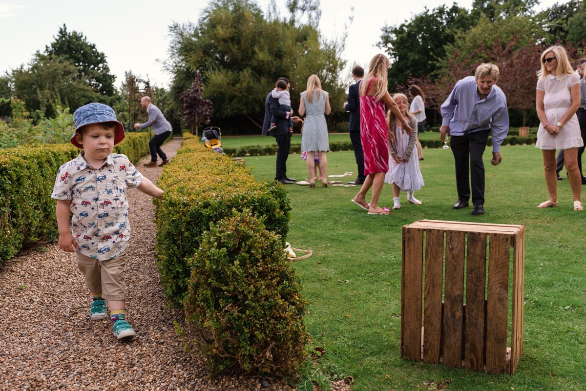 Guests enjoy games at sarah and Chris's wedding at the secret garden