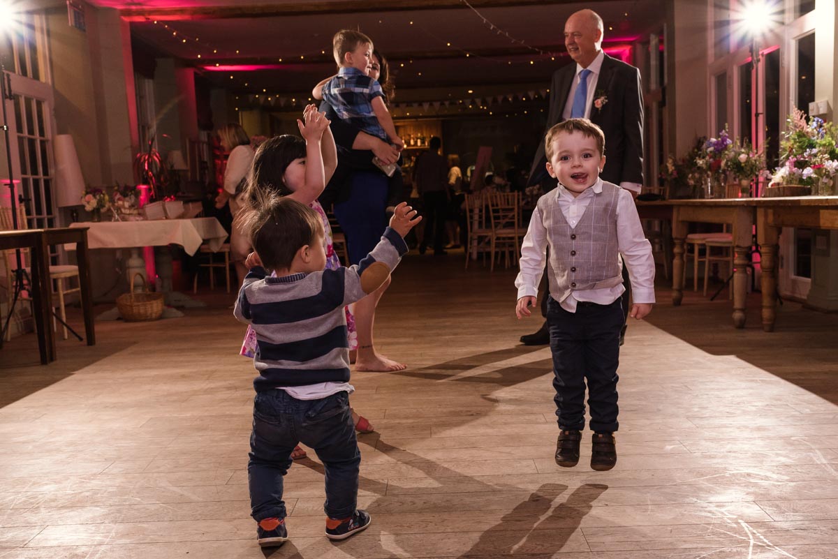 Little children dancing at secret garden wedding reception