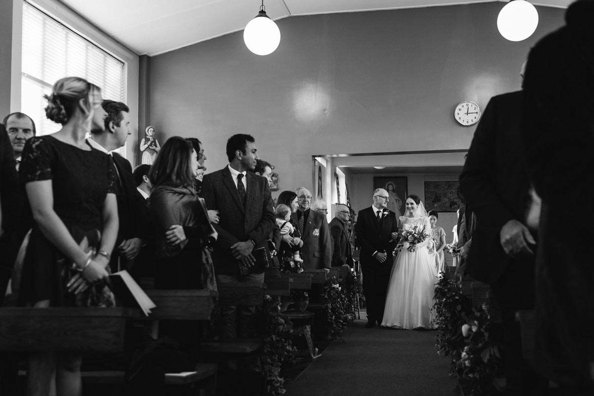 Katherine and her dad walk down the aisle during her Yorkshire church wedding