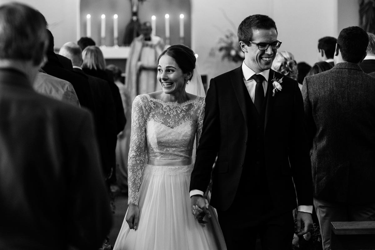 Katherine and Tom walk down the aisle after their church wedding in Yorkshire