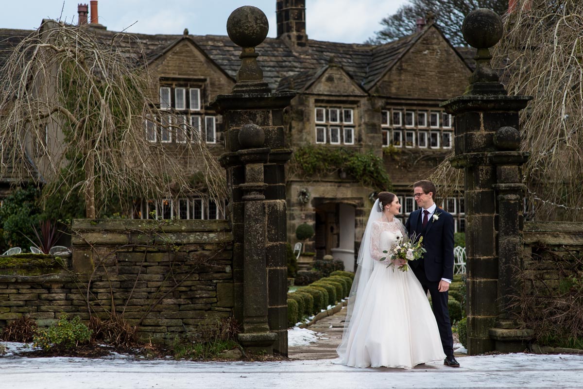 Holdsworth House wedding photography. Katherine and Tom standing at the front of the house.
