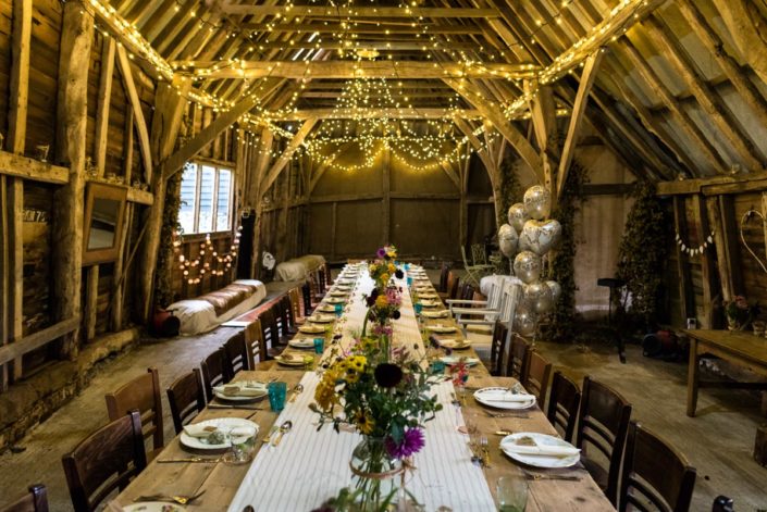 Fairy lights and garden flowers decorate Kent barn for wedding