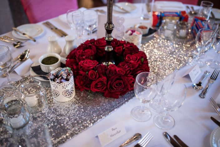 Ring of red roses as wedding table centre piece
