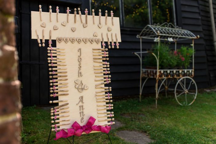 Photograph of seating plan made up of pegs with guests names on