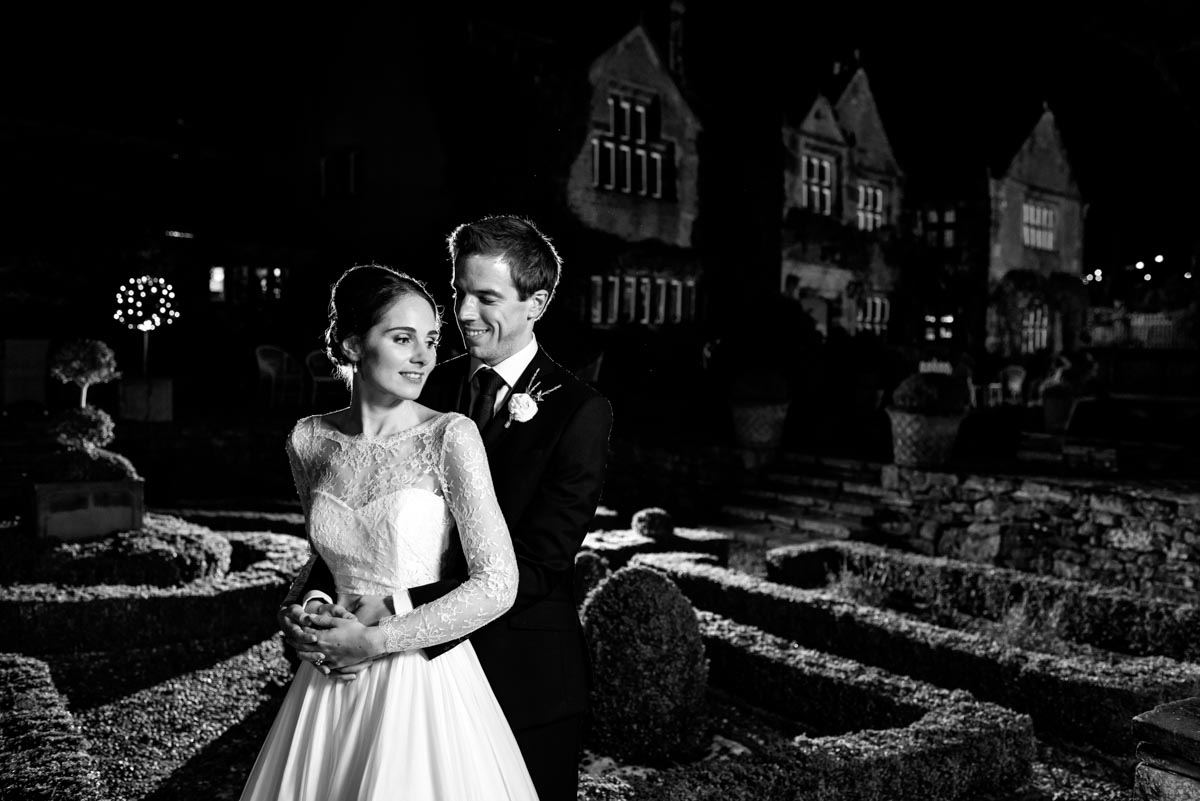 Flash lit portrait of tom and katherine at night on their wedding day at holdsworth house