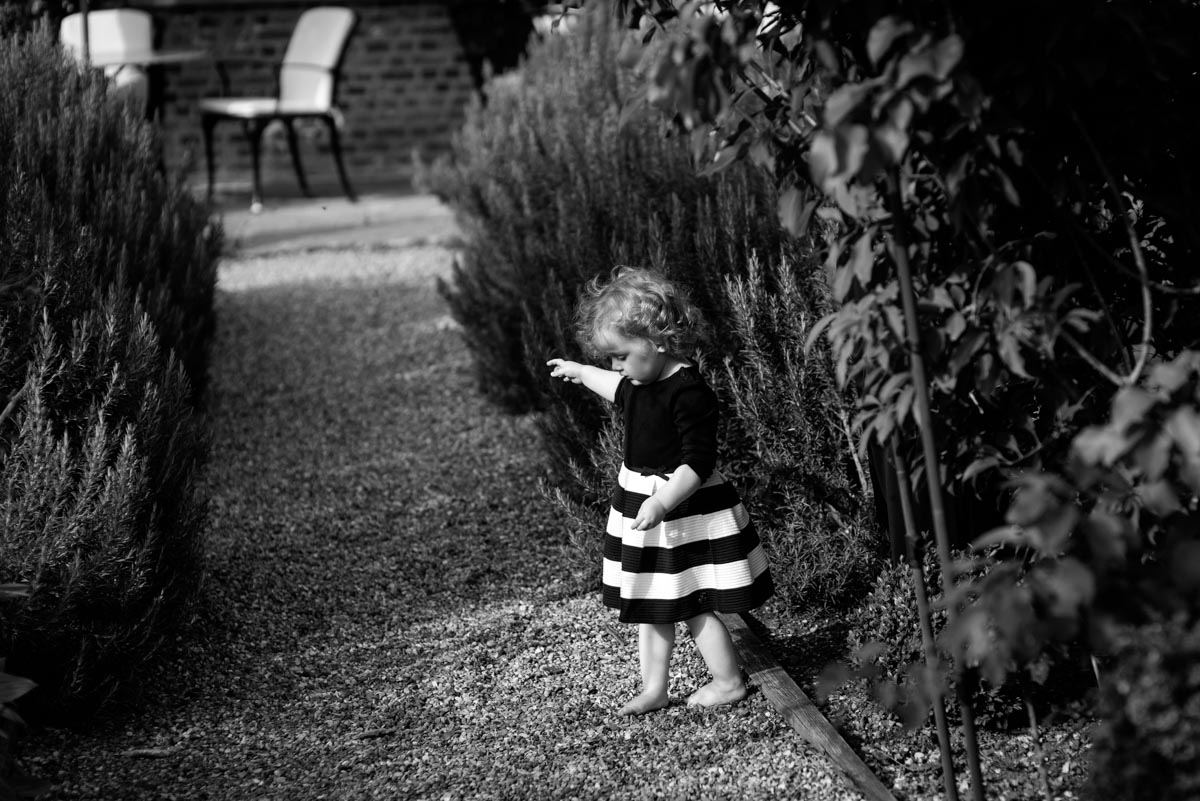 photograph of little girl in stripy skirt at Secret Garden wedding in Kent