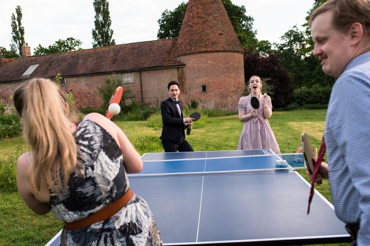 guests play table tennis at ratsbury Barn wedding in kent