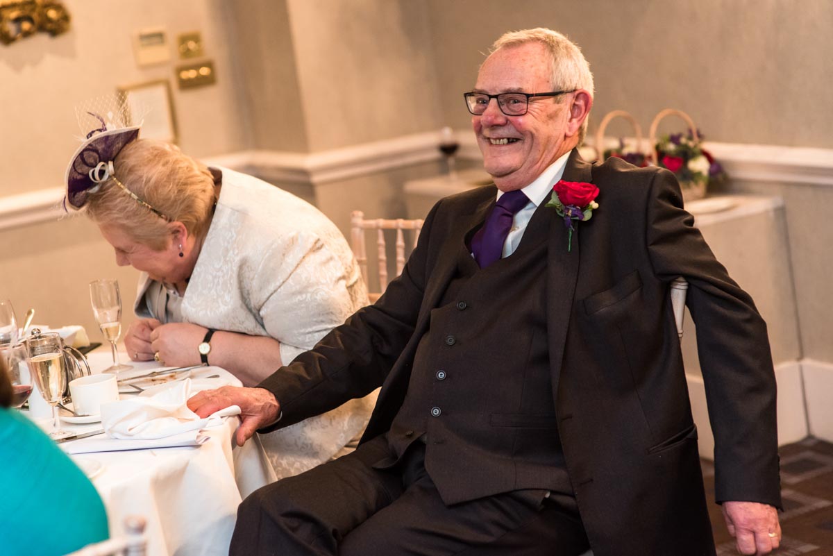 Photograph of Graham laughing during the speeches at his wedding at Chilston park hotel in Kent