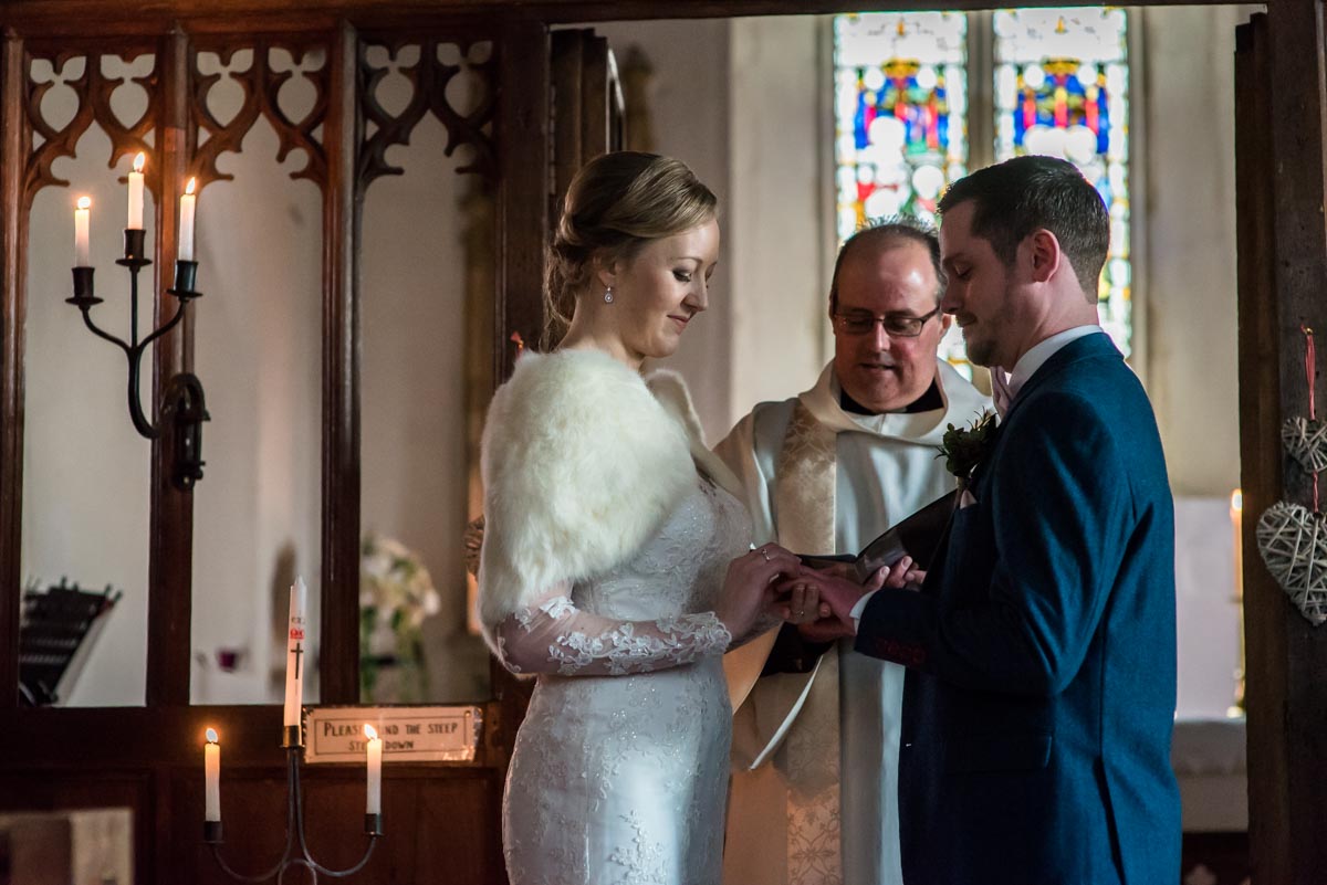 Rebecca is photographed putting wedding ring on Stephens finger during Kent church ceremony
