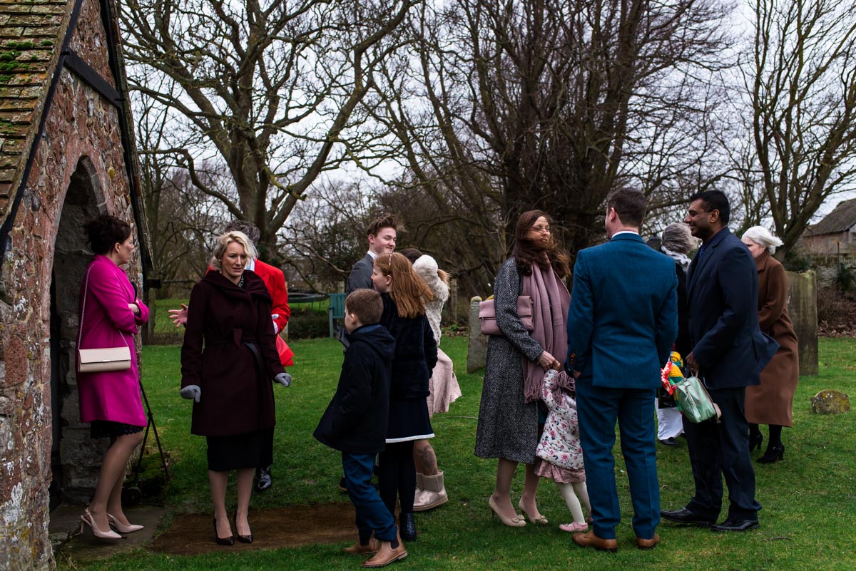 Guests photographed waiting outside Kent church after Rebecca and Stephens ceremony