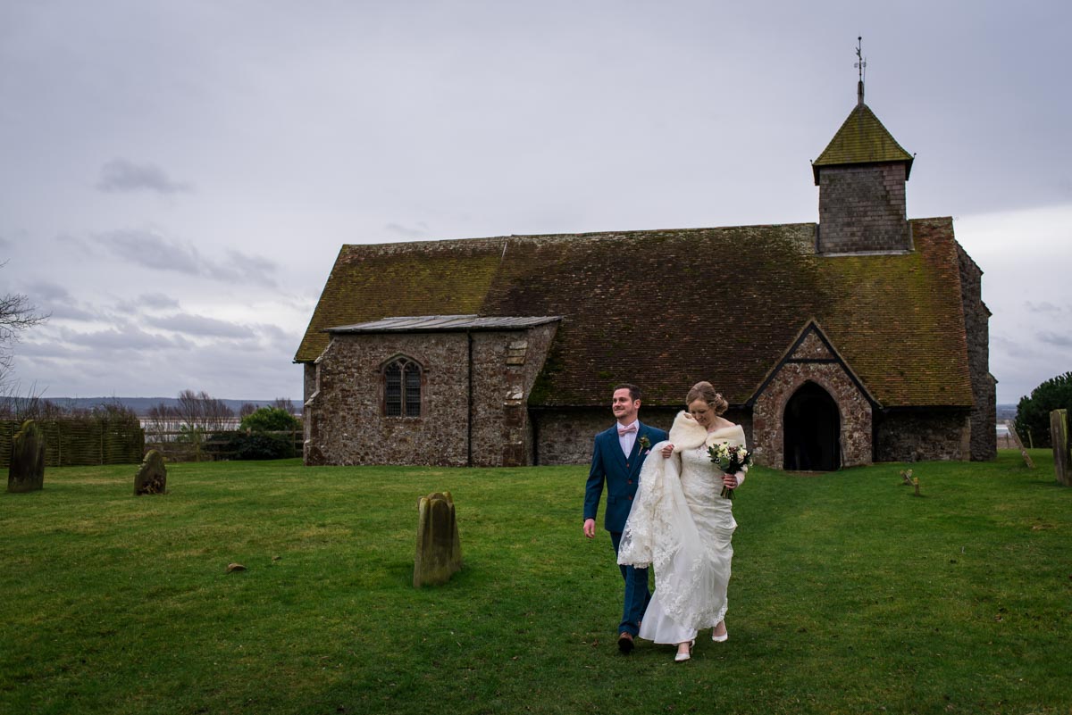 Kent wedding photographer captures bride and groom leaving St Thomas's church after their winter ceremony