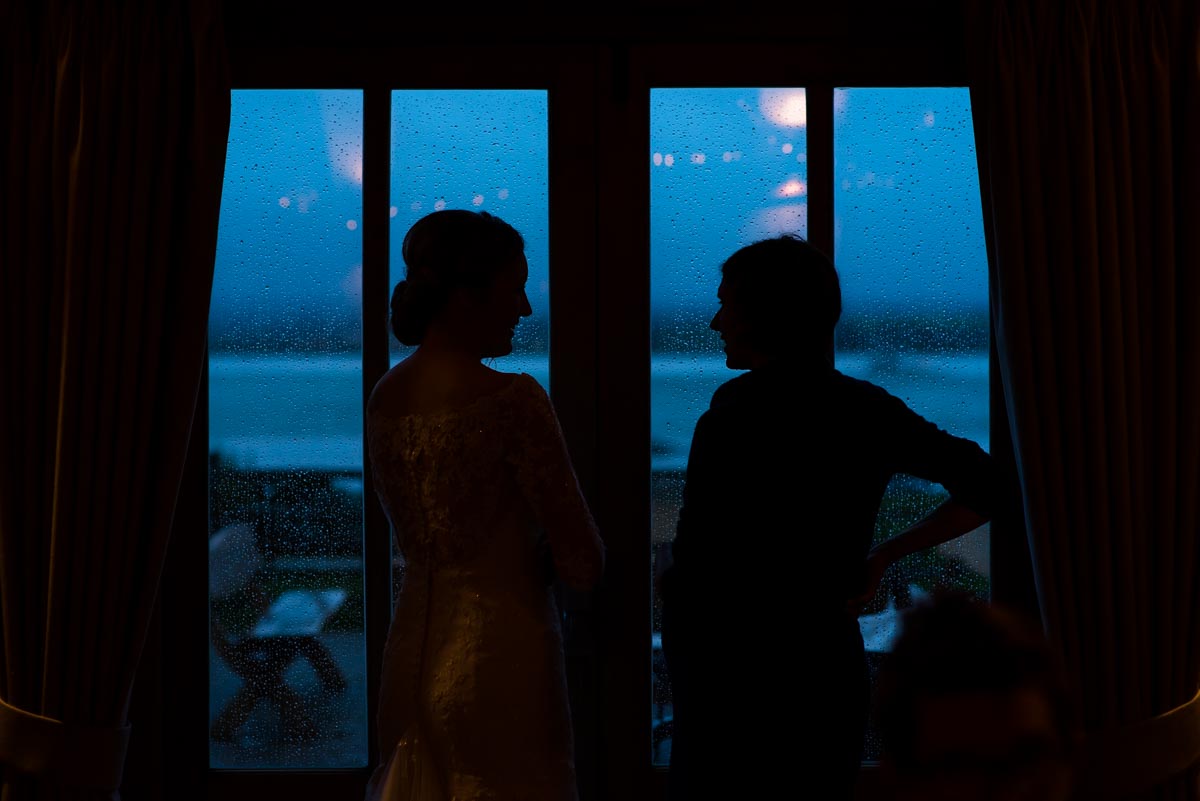 Silhouette photograph of Rebecca and guest at her Ferry house Inn wedding in Kent