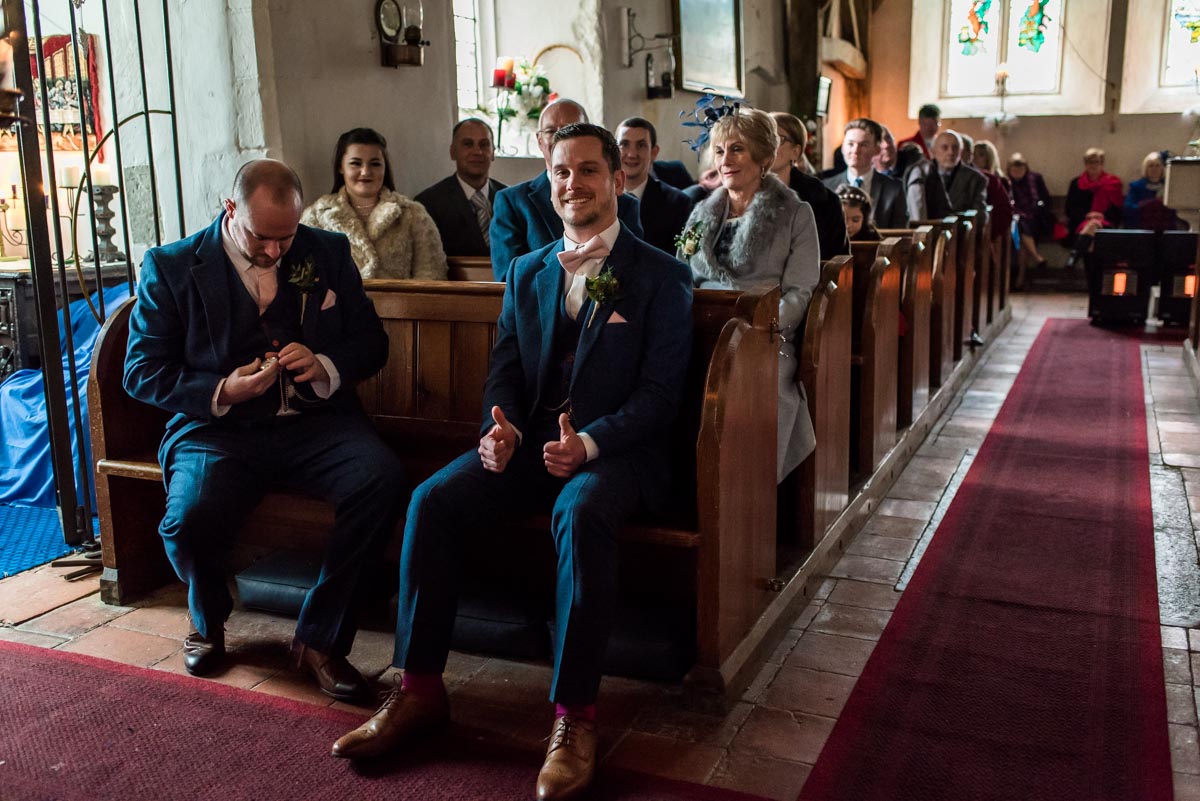 The groom is photographed giving the thumbs up before his Kent wedding ceremony