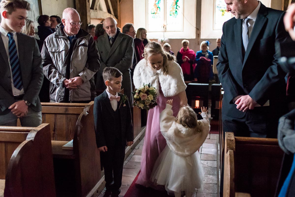 Photograph of Rebeccas bridesmaid, flower girl and page boy in Kent church on her wedding day