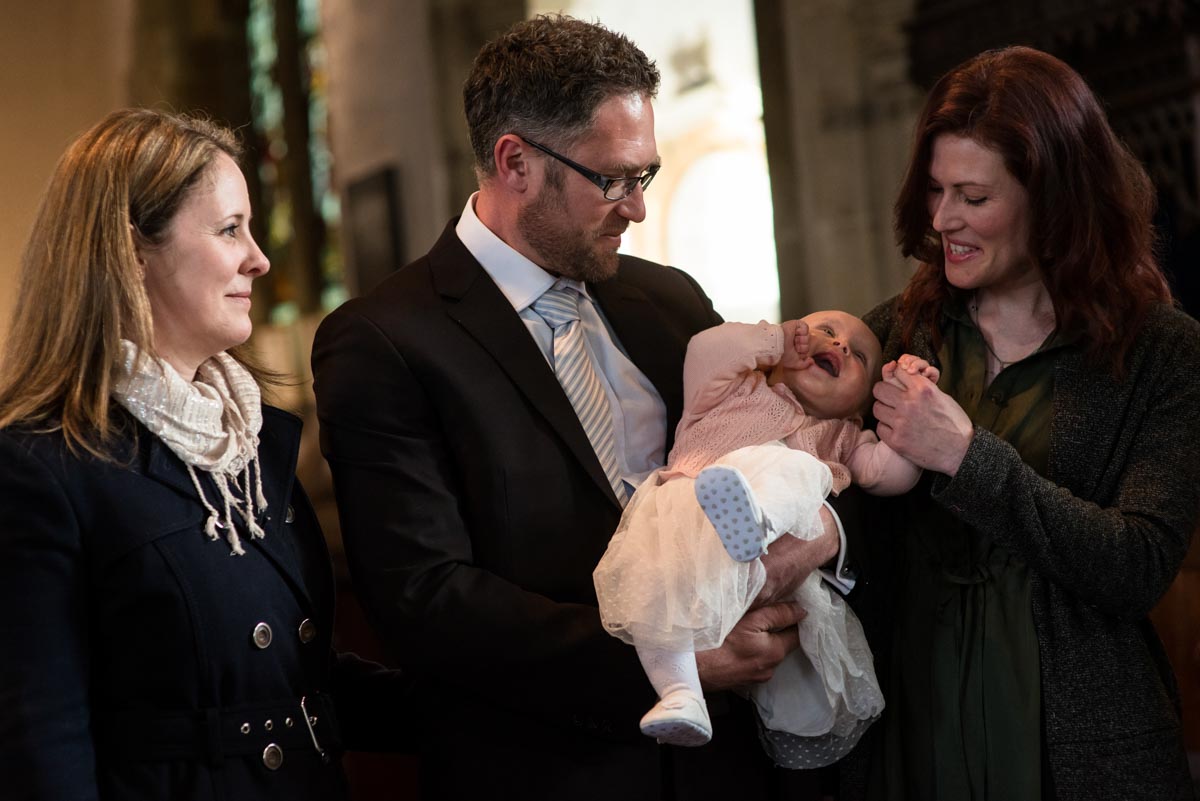 Emily is photogra[phed with her parents during her christening in Kent