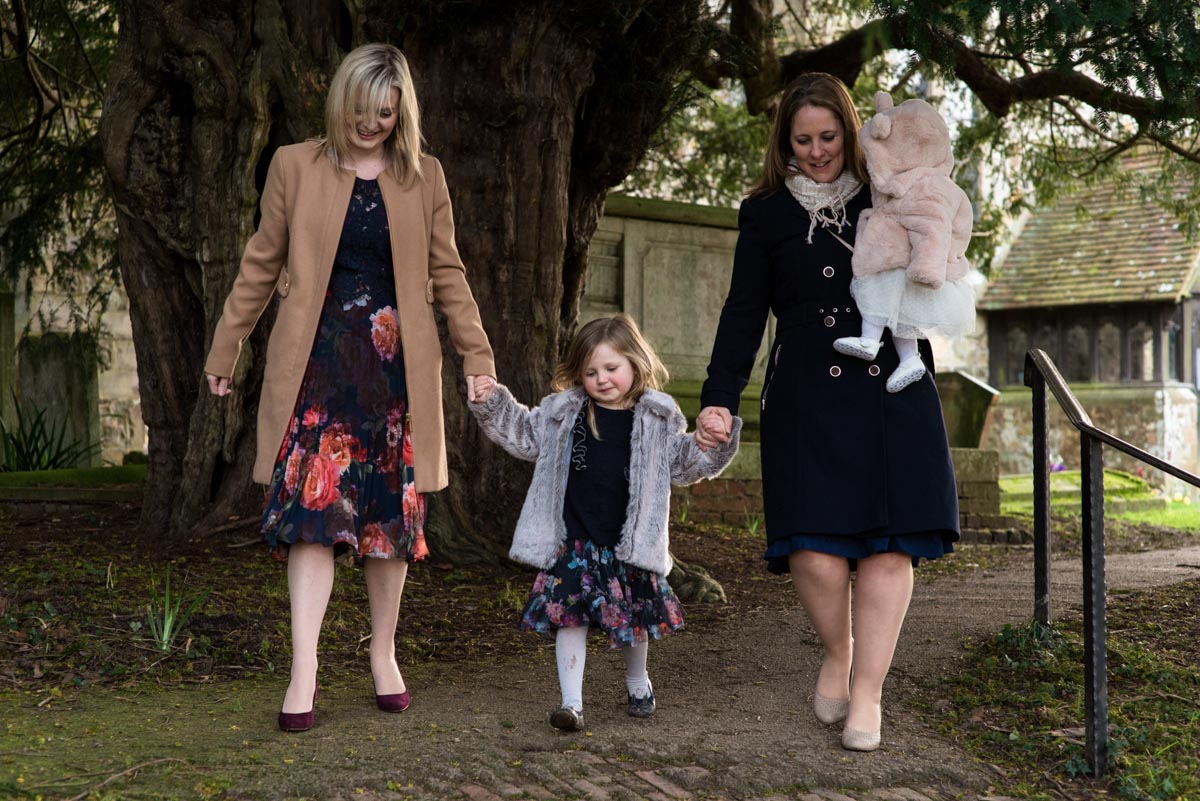Photograph of Emily and her mum with friends on the day of her christening