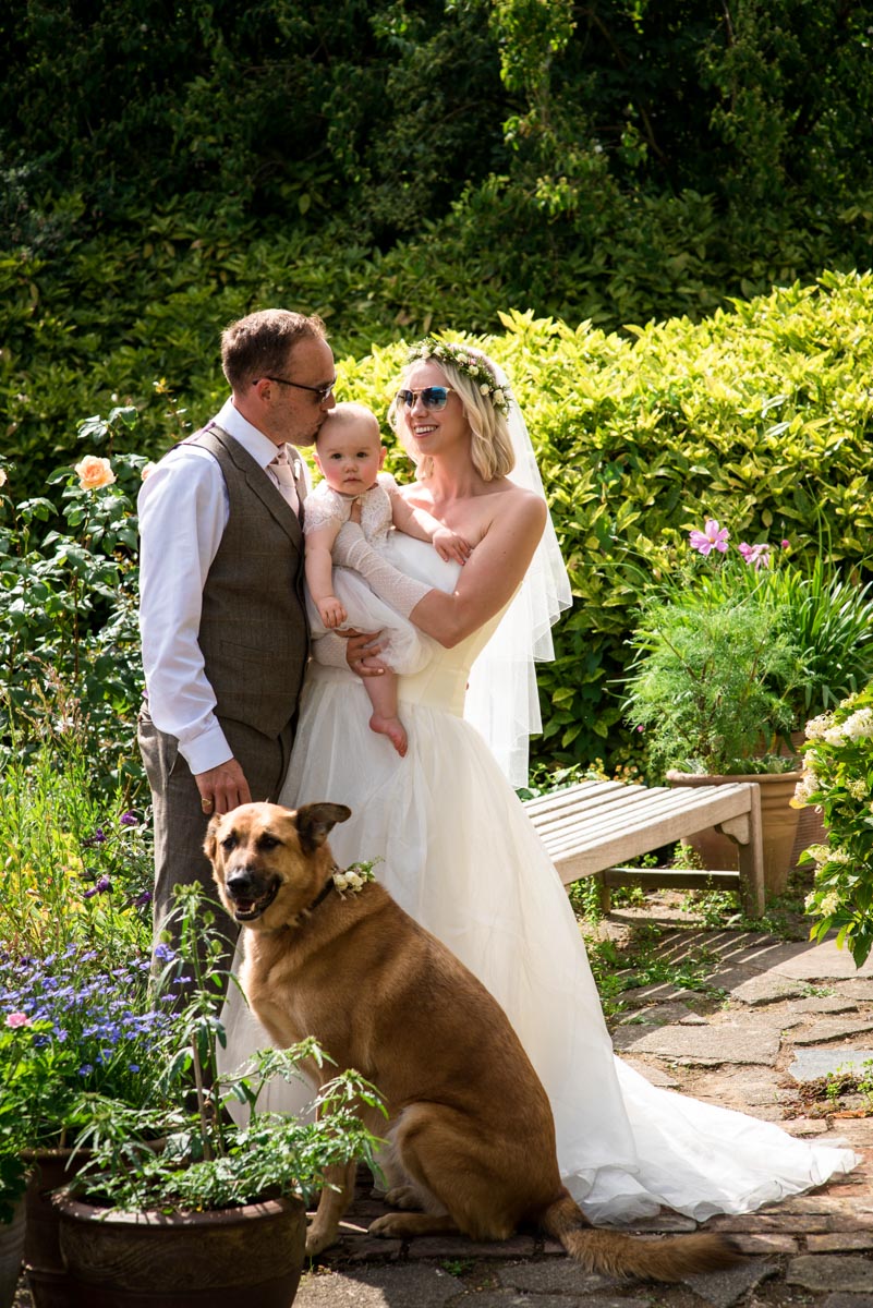 Photograph of Ann and Josh with their baby and dog on their wedding day