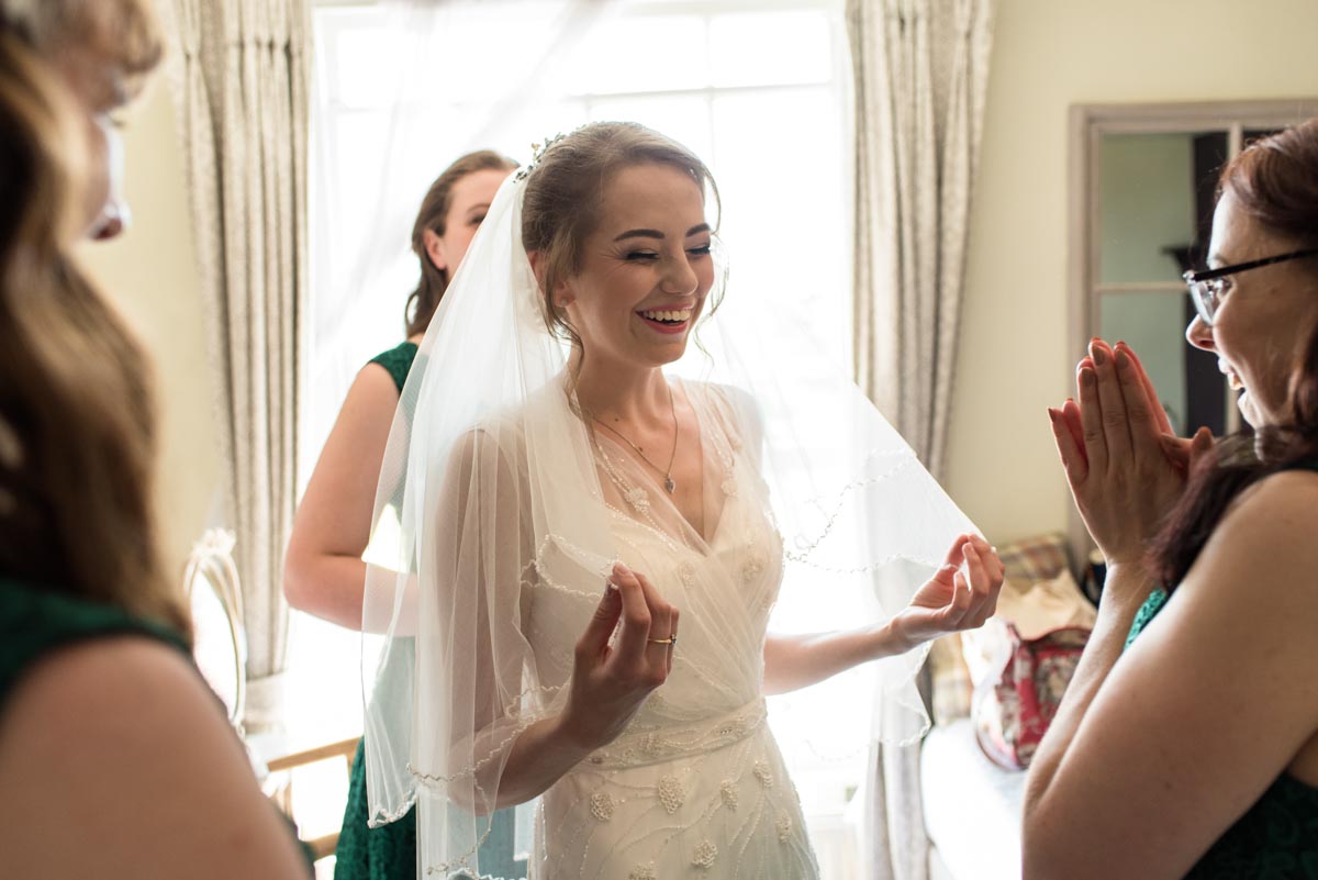 Bride and her bridemaids photographed enjoying getting ready