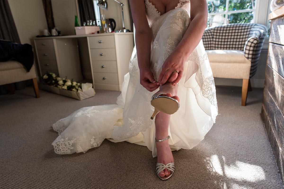 Photograph of Lindsey doing her wedding shoes up
